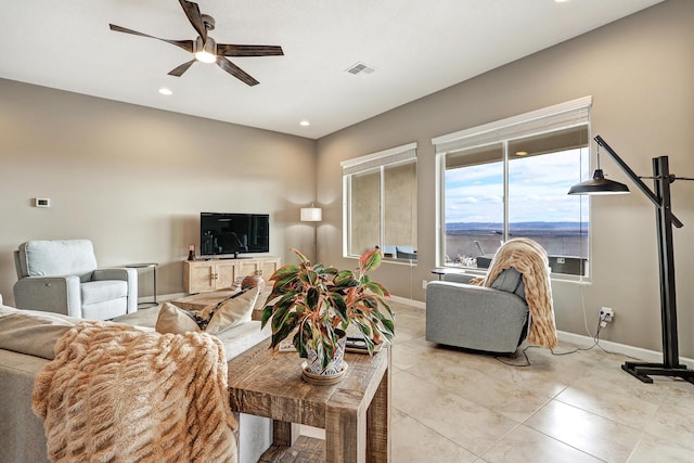 living area with light tile patterned floors, baseboards, visible vents, a ceiling fan, and recessed lighting