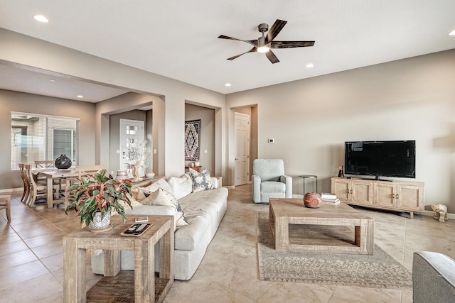 living room featuring recessed lighting, a ceiling fan, and baseboards