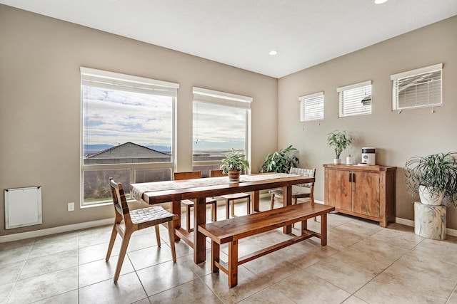 tiled dining space featuring plenty of natural light