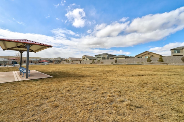 view of yard featuring a patio and a residential view