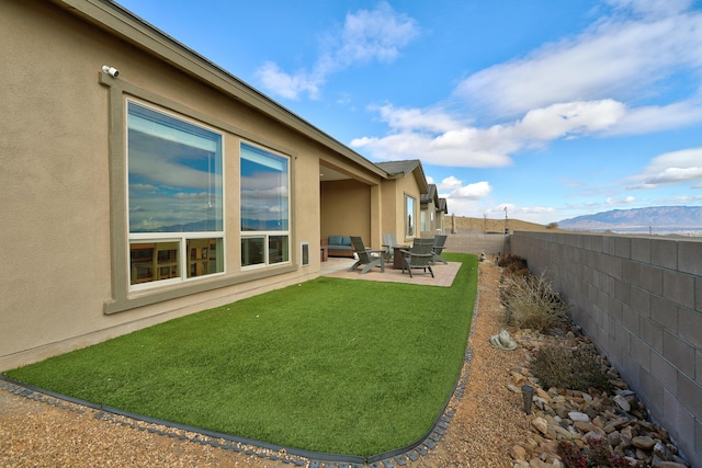 view of yard with a mountain view and a patio area