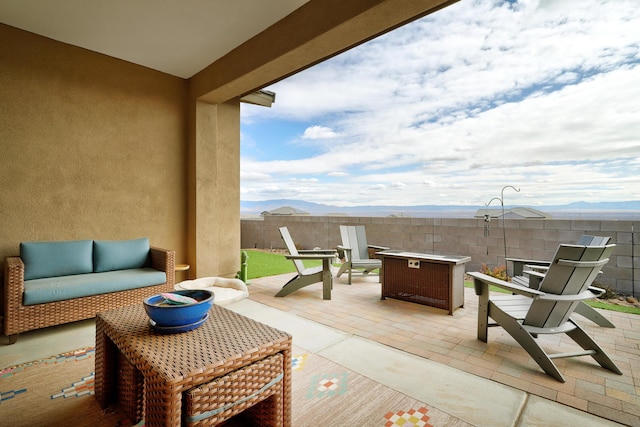 view of patio featuring an outdoor living space and a mountain view