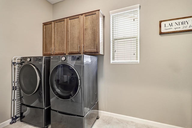 laundry area with cabinets and washing machine and dryer