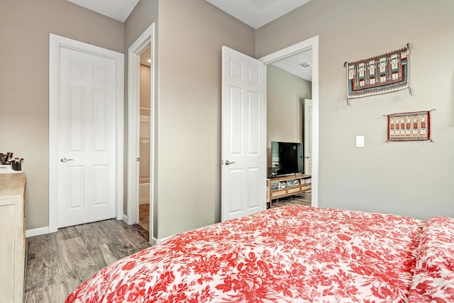 bedroom with baseboards and wood finished floors