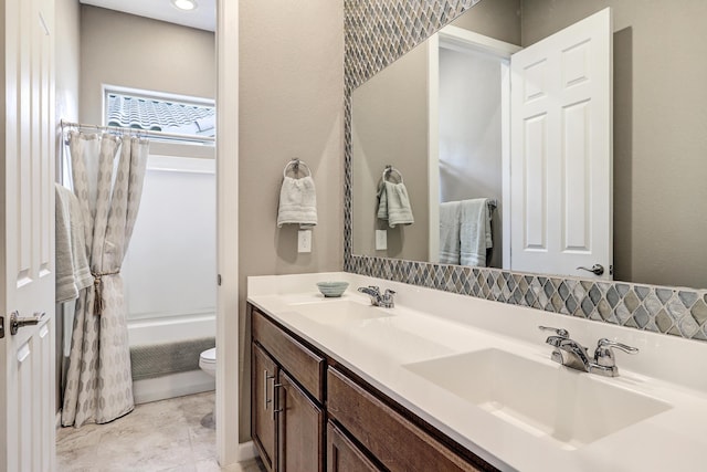 full bath with toilet, shower / bath combination with curtain, double vanity, and a sink