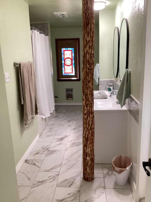 bathroom featuring vanity and a shower with shower curtain