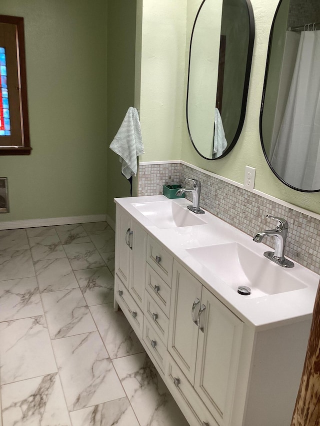 bathroom with tasteful backsplash and vanity