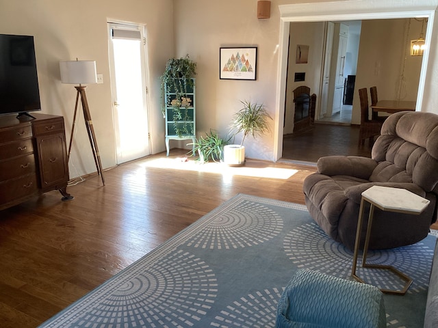 living room featuring wood-type flooring and a notable chandelier