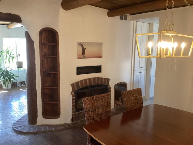 dining space with beamed ceiling and an inviting chandelier