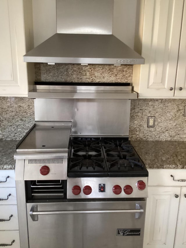 kitchen with white cabinets, backsplash, and wall chimney exhaust hood