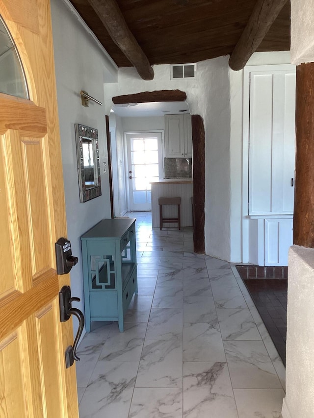 hallway featuring beam ceiling and wood ceiling