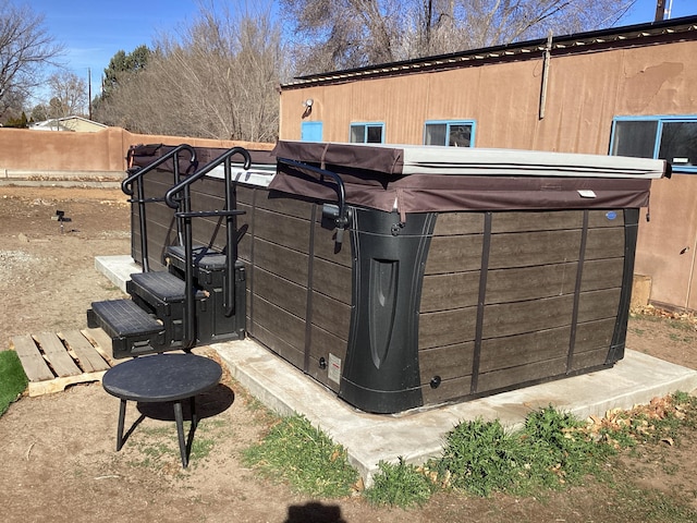 exterior space with a hot tub