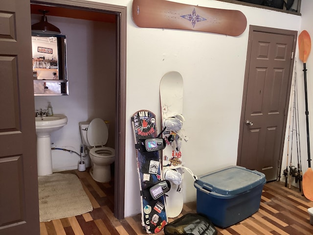 bathroom with sink, toilet, and hardwood / wood-style floors