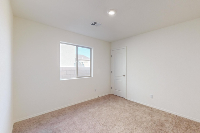 unfurnished room with light carpet