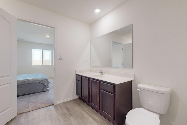 bathroom featuring hardwood / wood-style floors, toilet, and vanity