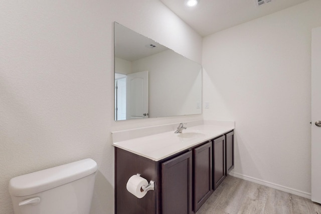 bathroom featuring hardwood / wood-style floors, toilet, and vanity