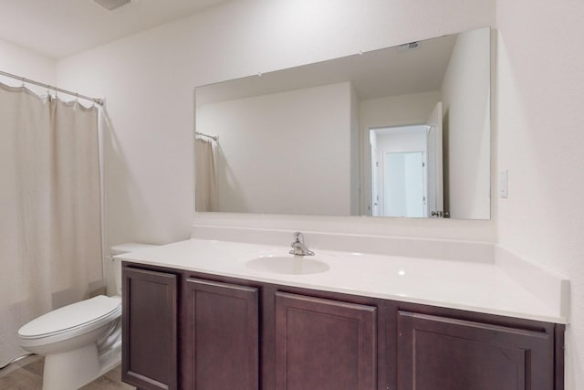 bathroom with vanity, toilet, curtained shower, and hardwood / wood-style flooring