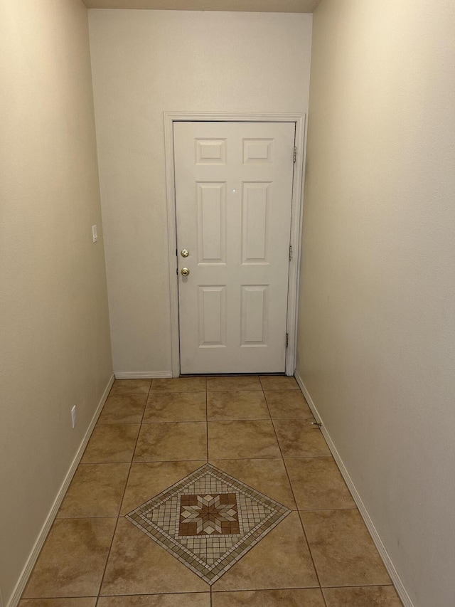 doorway to outside with light tile patterned floors