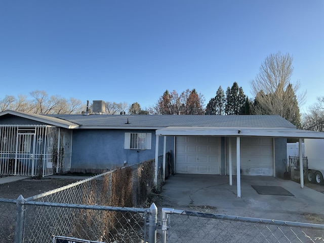 view of front facade featuring a garage and central air condition unit