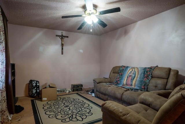 living room featuring light carpet, ceiling fan, and a textured ceiling