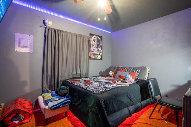 bedroom featuring a textured ceiling and ceiling fan