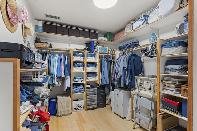 walk in closet featuring light hardwood / wood-style flooring