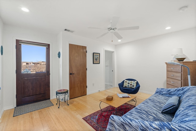 living room with ceiling fan and light wood-type flooring