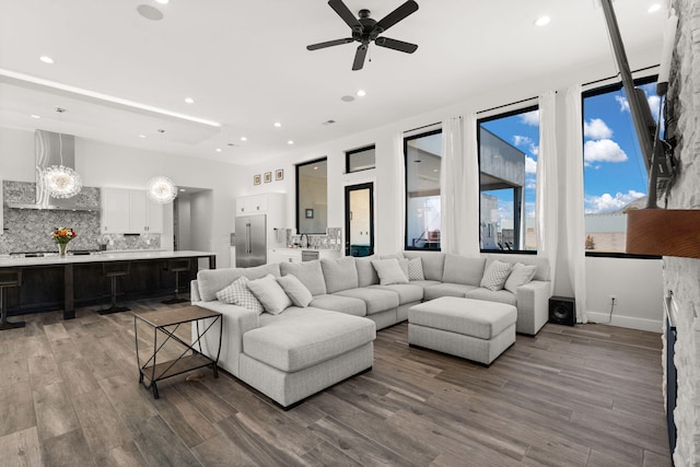 living room with dark hardwood / wood-style floors and ceiling fan