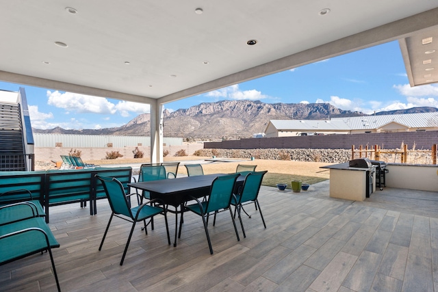 view of patio / terrace with grilling area and a mountain view