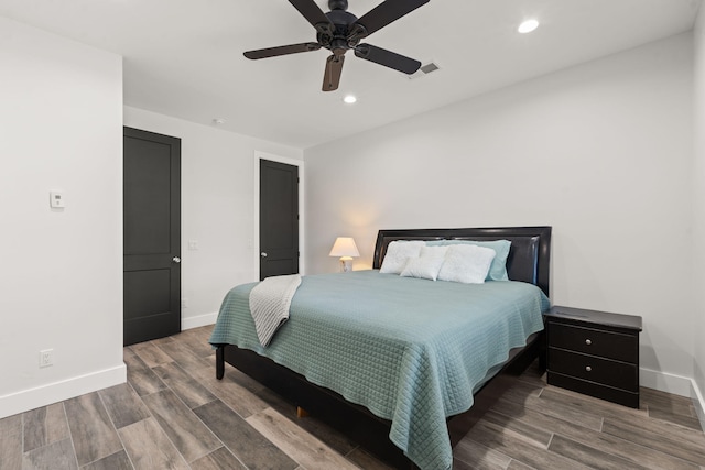 bedroom with hardwood / wood-style floors and ceiling fan