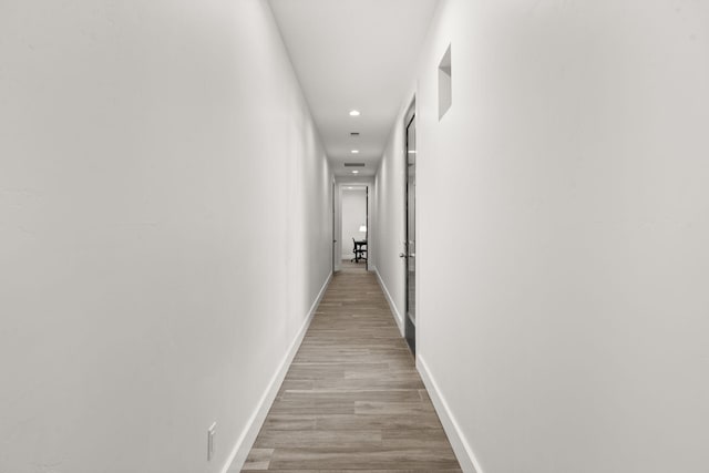 hall with light hardwood / wood-style flooring