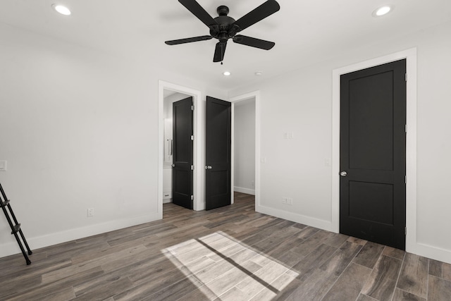 unfurnished bedroom with ceiling fan and dark hardwood / wood-style floors