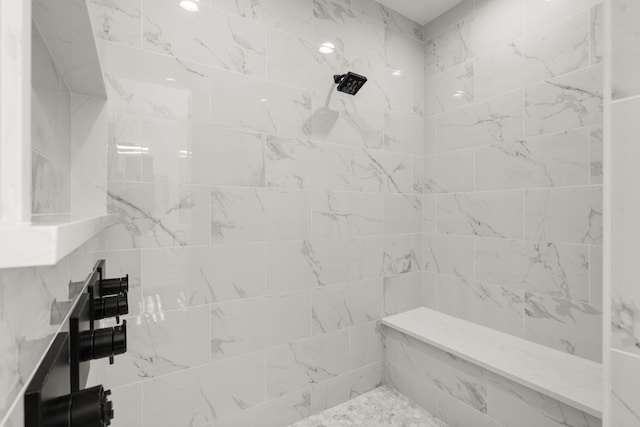 bathroom with a tile shower