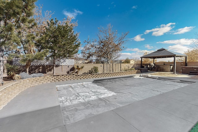 view of patio featuring a gazebo and a hot tub