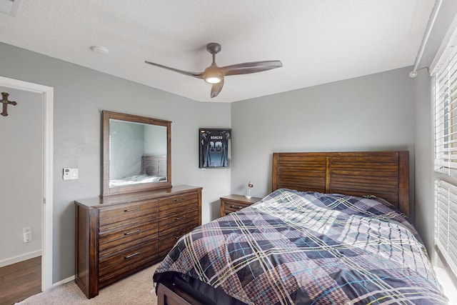 bedroom featuring ceiling fan and light carpet