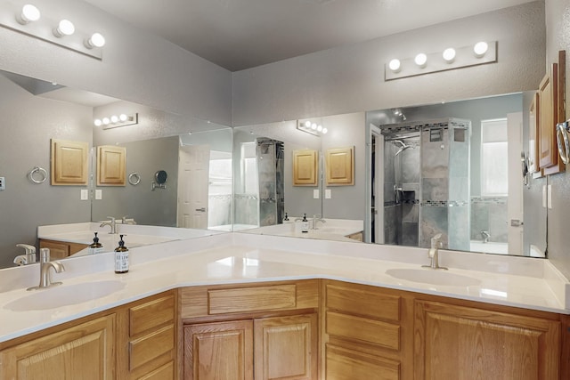 bathroom with vanity and a shower with door