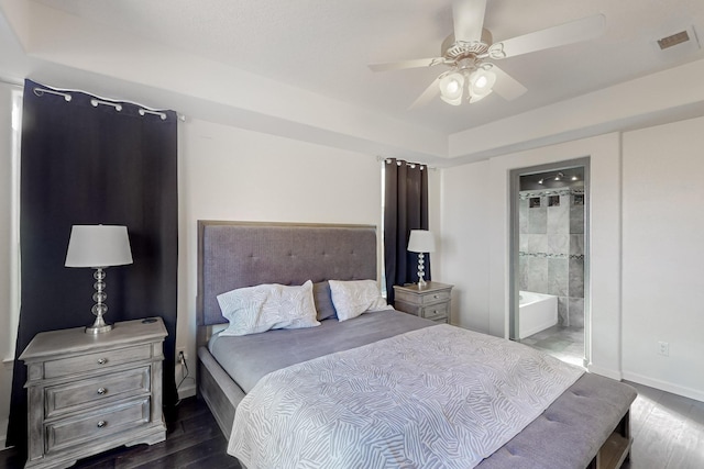 bedroom featuring ceiling fan, dark wood-type flooring, and ensuite bath