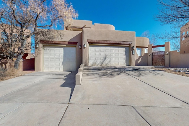 pueblo revival-style home with a garage