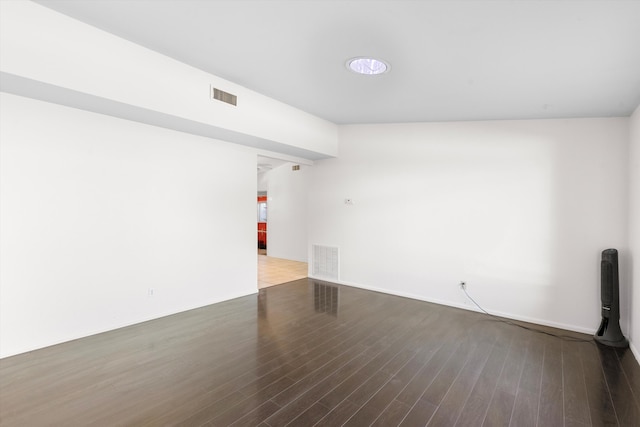 empty room with dark hardwood / wood-style floors