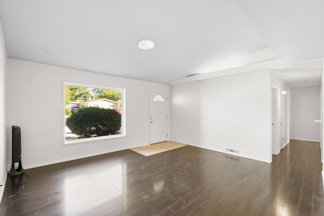 foyer featuring dark hardwood / wood-style floors and vaulted ceiling