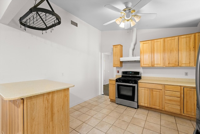 kitchen with ceiling fan, light tile patterned flooring, light brown cabinets, and stainless steel gas range oven