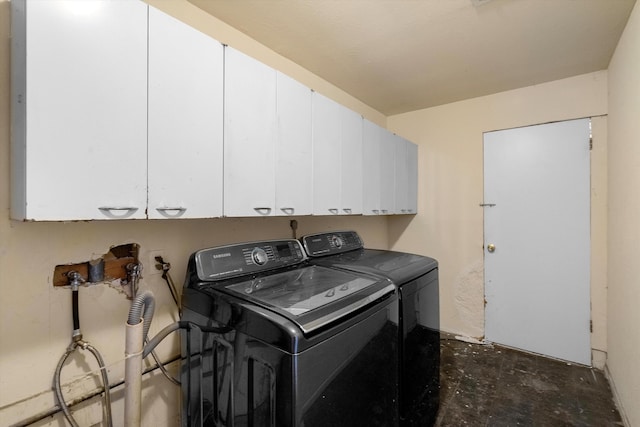 washroom featuring cabinets and washer and dryer