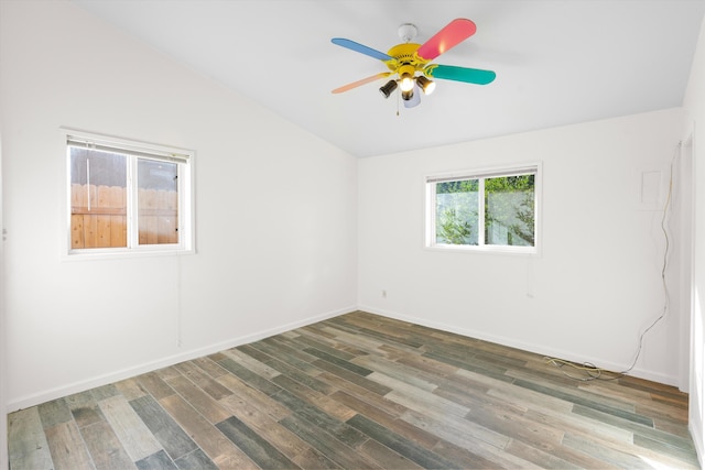 empty room featuring dark hardwood / wood-style floors, vaulted ceiling, and ceiling fan