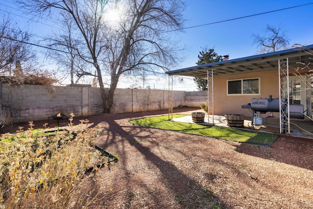 view of yard with a patio and a fire pit