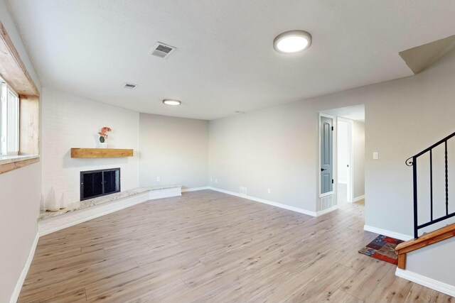 unfurnished room featuring light wood-type flooring and a textured ceiling