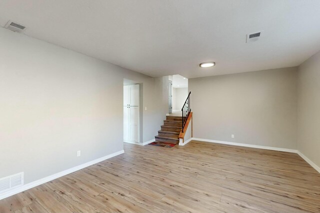 unfurnished living room with a fireplace and light hardwood / wood-style flooring