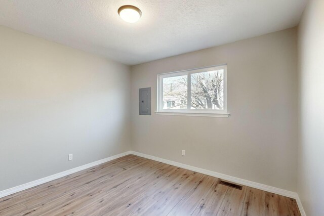 unfurnished bedroom featuring a closet, light hardwood / wood-style floors, and a textured ceiling