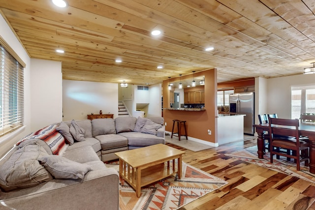 living room with wood ceiling and light wood-type flooring