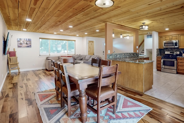 dining area with wood ceiling and light wood-type flooring