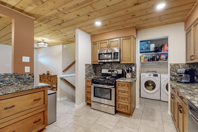 kitchen featuring tasteful backsplash, dark stone countertops, wooden ceiling, stainless steel appliances, and washer and clothes dryer